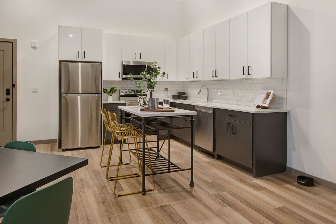 Chef-inspired kitchens feature stainless-steel appliances, sleek quartz countertops, and clean tile backsplashes.