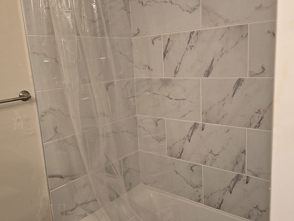 new tub / shower with tile to ceiling.
