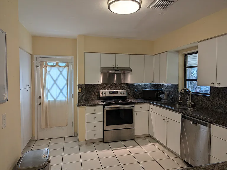 Large kitchen with stainless steel appliances and plenty of storage space.