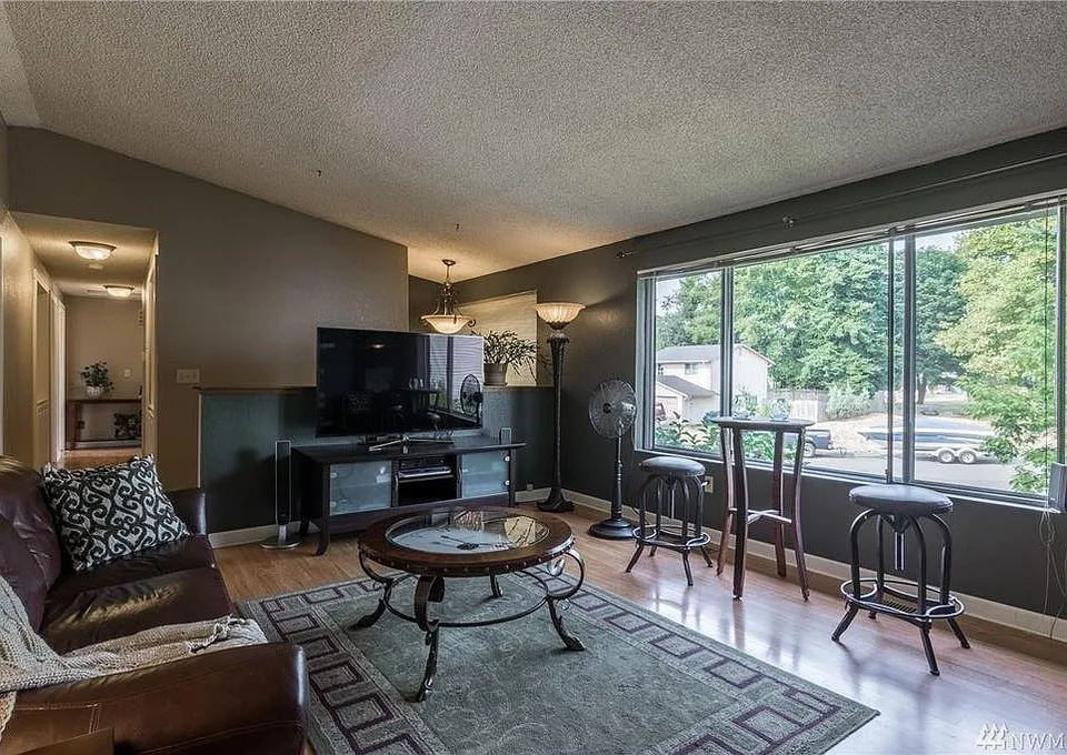 Livingroom Veiw from Diningroom Entry- Large Windows provide natural light.