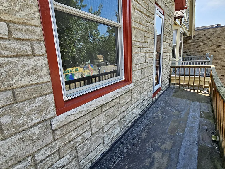 Unit provides a private front upper porch accessible through the unit's living room.