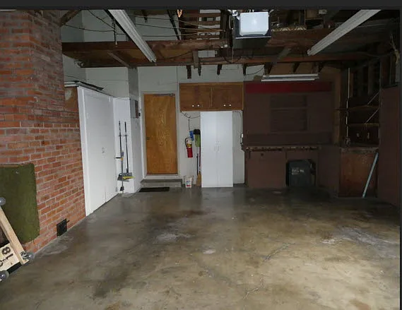Large 2 car garage with work bench and lots of overhead storage