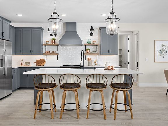 Kitchen with pendant lighting and stylish tile backsplash