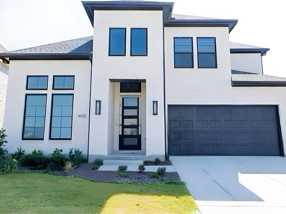 View of front of house with concrete driveway, a front yard, stucco siding, and a shingled roof