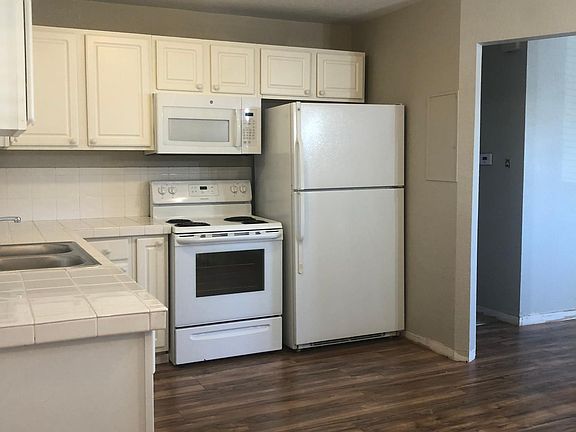 All white appliances and cabinets with plenty of storage space.