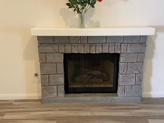 Fireplace with mantel in great room.