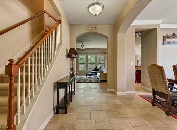 Entry/foyer of home with formal dining to the right. Bonus room upstairs to the left.