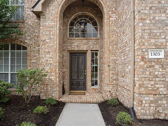 The front porch of 1303 Lambourne Circle, with great curb appeal, and a brick elevation.