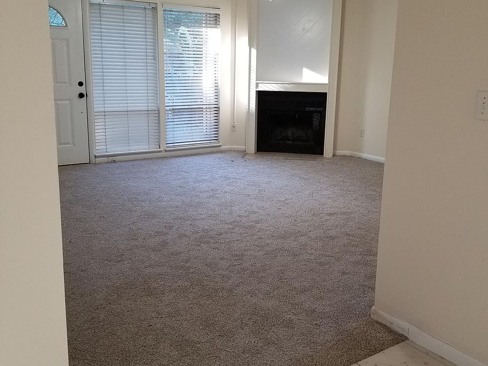 Large living room with fire place and new carpet