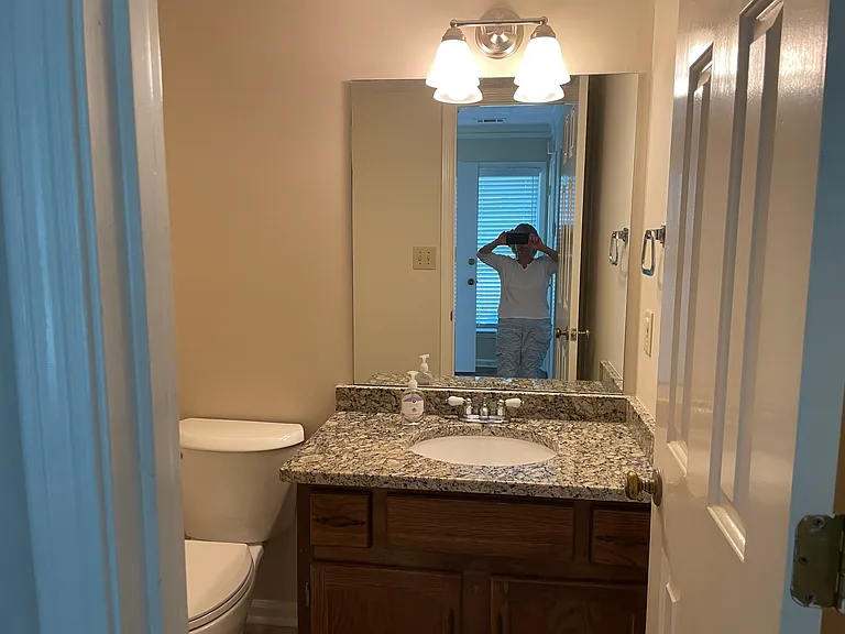 Hallway bathroom with granite, new fixtures, and upgraded tile flooring.