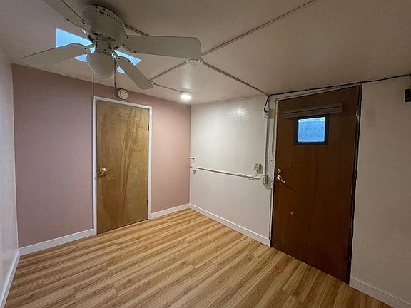 North bedroom with side door and skylight