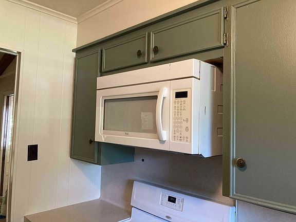 Kitchen with new dishwasher, gas stove/oven, microwave, refrigerator, large pantry, ceiling fan and garbage disposal.