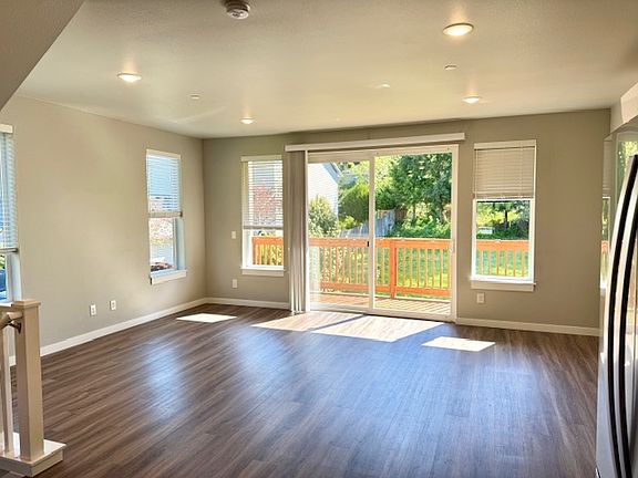 End unit gets tons of natural light! 
Oversized sliding door open onto a large cedar deck overlooking the greenbelt behind