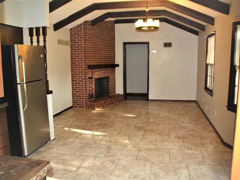 Hearthroom kitchen area with tile flooring. This room has been used for 2nd living area or Very large table, vs one in kitchen bay window area.