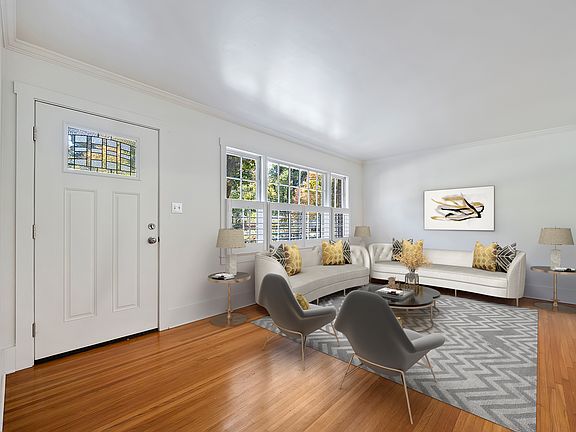 Light and bright entryway and living area with partial plantation shutters.