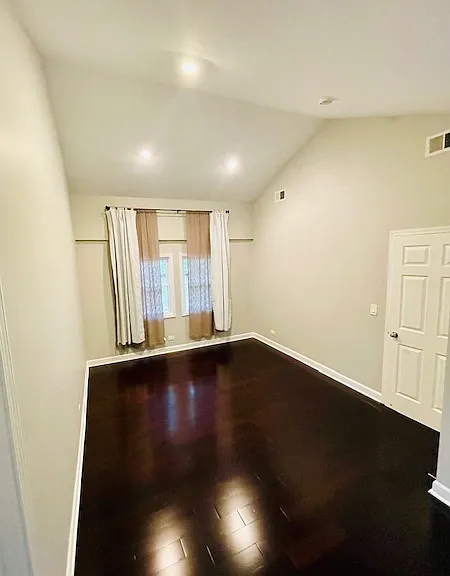 Primary bedroom has vaulted ceilings and walk-in closet