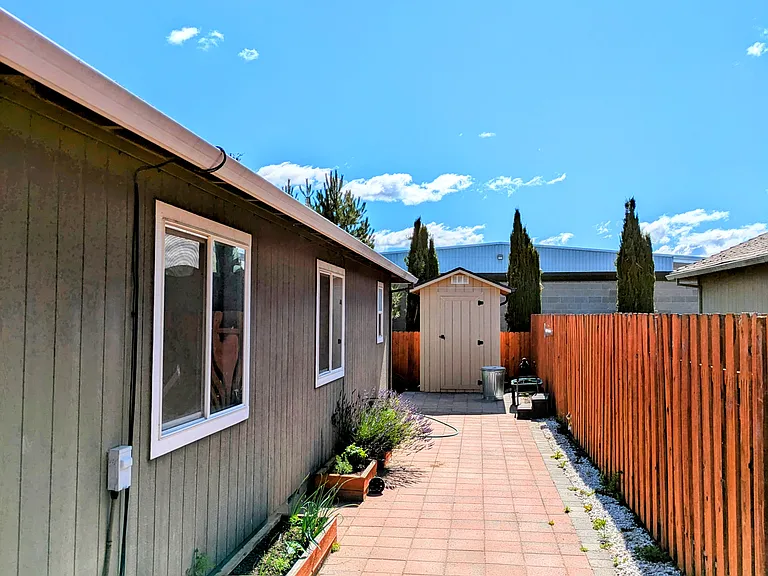 Side of the wrap-around yard. Similar brick path on opposite side.