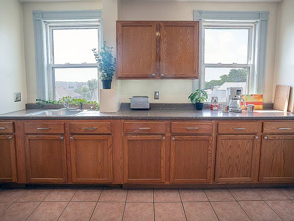 Kitchen includes full size stove, refrigerator, microwave, compact dishwasher.