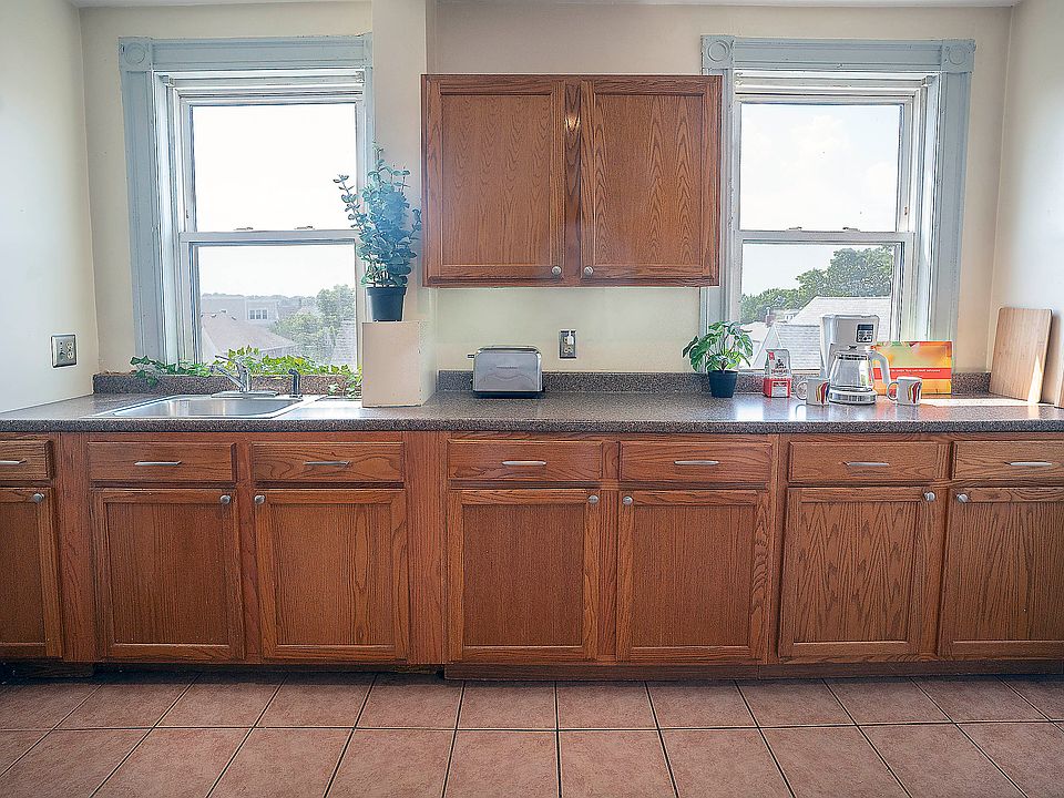 Kitchen includes full size stove, refrigerator, microwave, compact dishwasher.