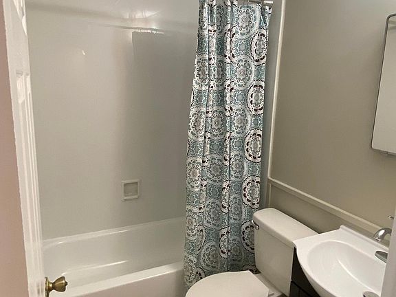 Bathroom has a new vanity and lighting.