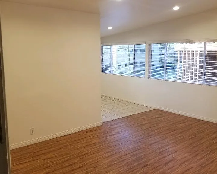 HUGE LIVING ROOM WITH HARDWOOD FLOORS, MINI BLINDS, RECESSED LIGHTING AND AIR CONDITIONING
