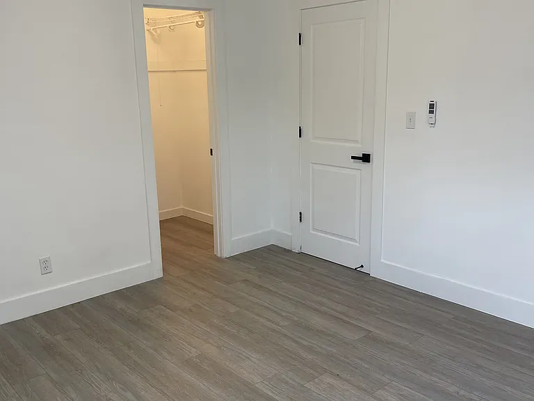 corner of master bedroom looking at the room door + walking closet door.