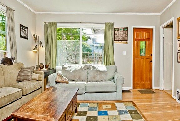 Gorgeous gleaming floors & large windows make this place light & bright! Front door is new as well.