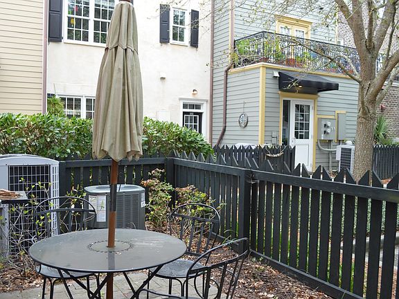 Patio is behind unit by parking - for use of this rental only. Business does not have access