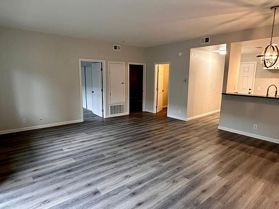 View from dining area of bedrooms, bathroom, entry area and kitchen