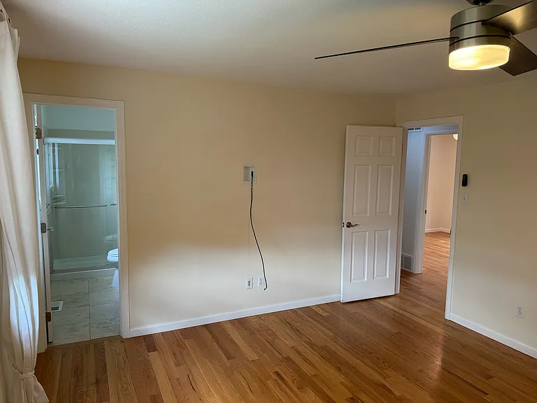 spacious primary bedroom with attached full bathroom