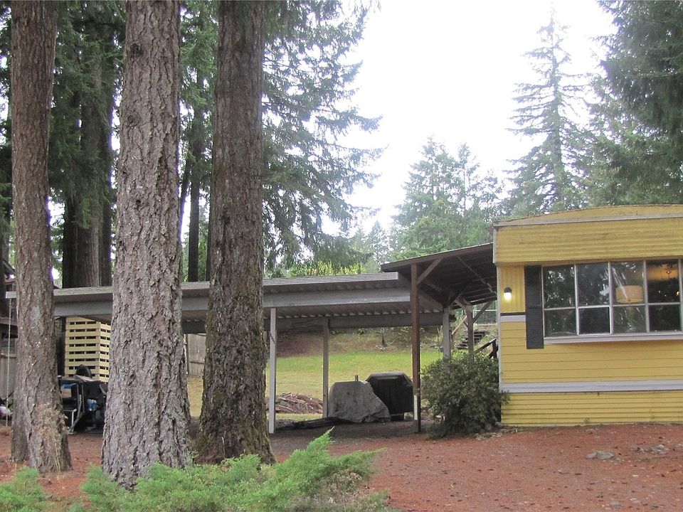 There are 3 sheds to the left of the carport.>