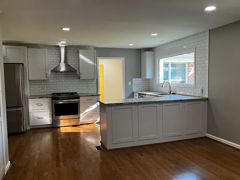 Den, looking into kitchen and showing door leading to Master Bedroom.