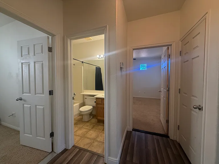 view from Laundry room into Master Bedroom straight ahead. Coat closet on the right. half left is 2nd Bath Left is 2nd Bedroom.