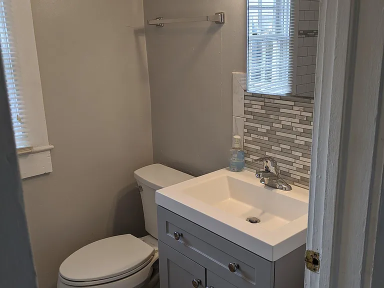 Bathroom has new fixtures, vanity, and floor.