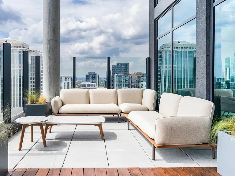 An elevated outdoor lounge frames sweeping Atlanta skyline views, offering a refined setting to relax or gather above the city.