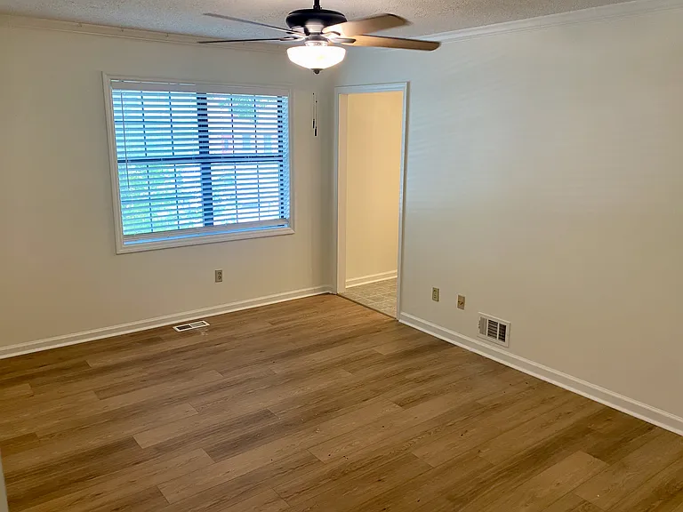 A bog picture window with blinds overlooking your front yard and parking spots.