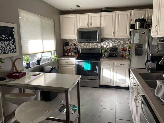 Kitchen - Fridge just over 1 year old. Dishwasher, induction stove and oven (pots included), microwave.
