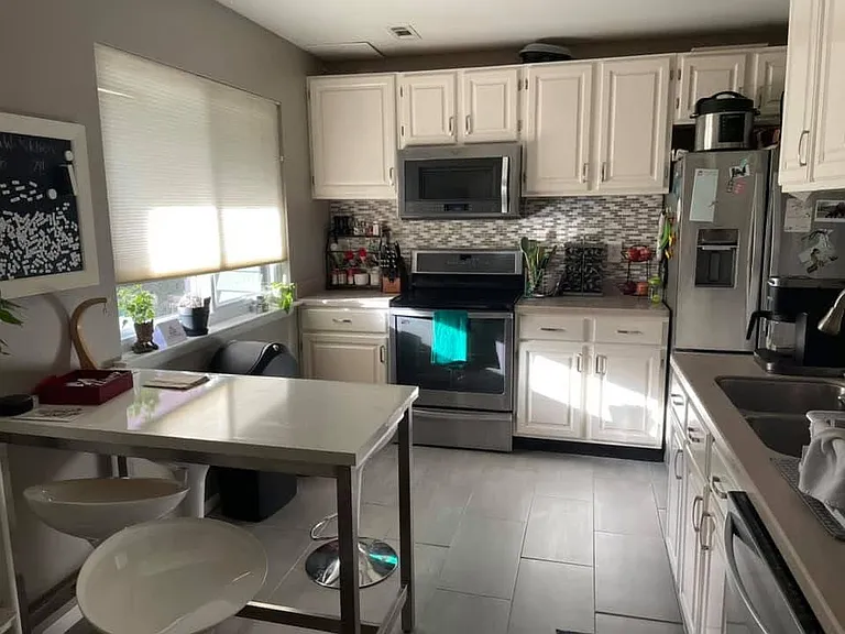 Kitchen - Fridge just over 1 year old. Dishwasher, induction stove and oven (pots included), microwave.