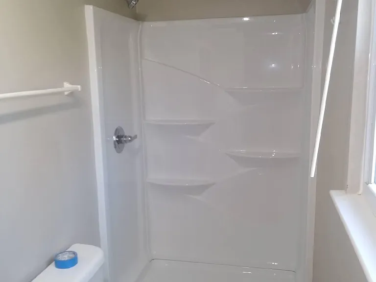 Ensuite bathroom with new shower surround, faucet and flooring