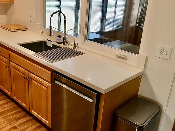 New stainless steel farmhouse sink and appliances throughout the kitchen.