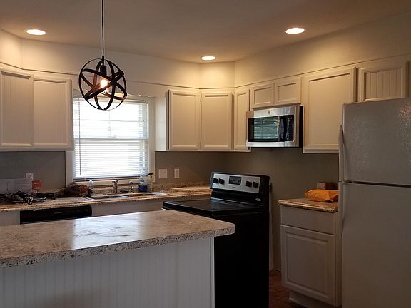 Kitchen includes brand new stove, built in microwave, dishwasher. Large island with bar stools.