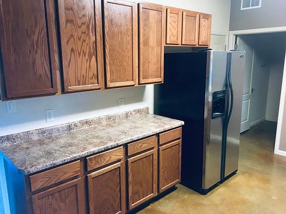 Kitchen, south side. Hidden by refrig is door to garage. Doorway seen is into laundry room