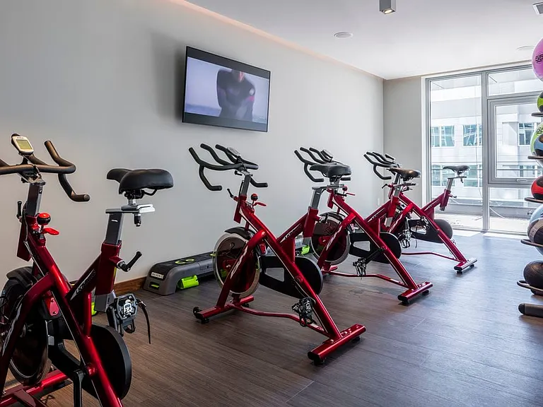 Fitness studio with spin bikes and virtual fitness programming.