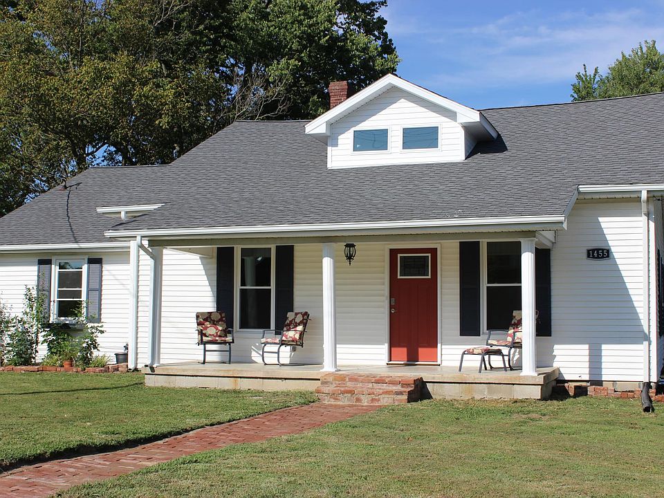 Front of the house. Brick walkway. New windows. Outside electrical outlet for decorations.