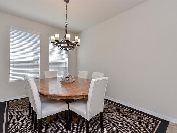 The formal dining room is light and bright. Tile flooring and neutral decor. Updated lighting by the seller. Plenty of room for entertaining.