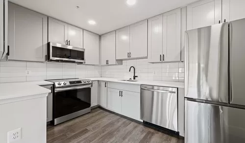Select homes feature upgraded kitchens with quartz countertops and wood flooring - The Residences at Capital Crescent Trail