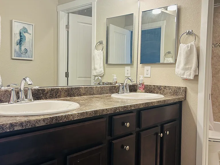 Full size bathroom on the upper level. Double sinks can be used separately while person uses bathroom section with bath or toilet.