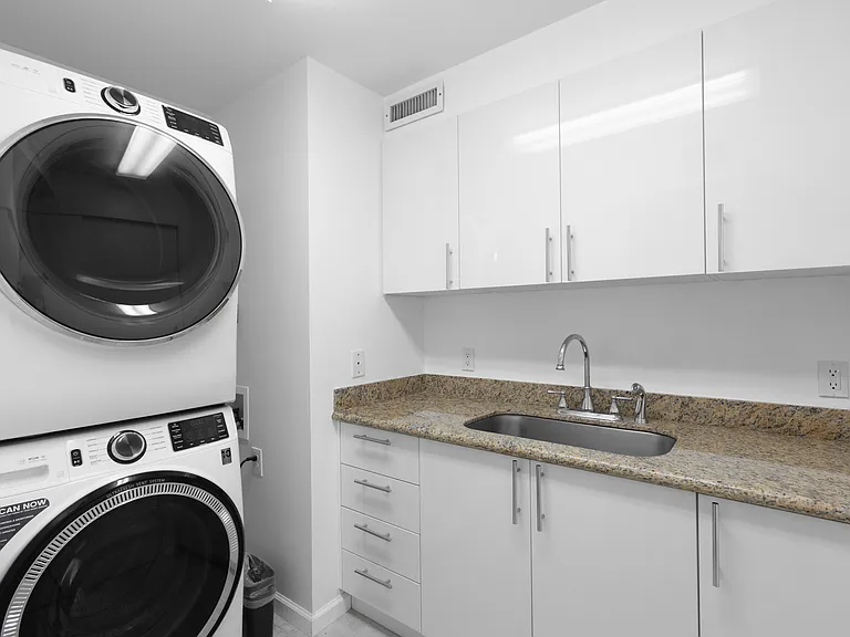 Stacked washer and dryer with utility sink