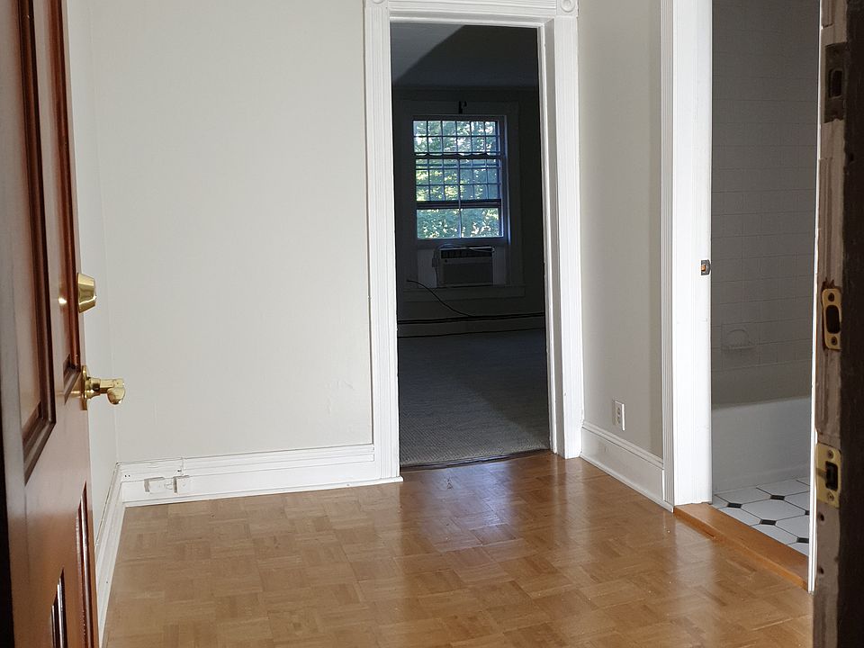 Welcoming entry with hardwood floors leads into a bright living space.