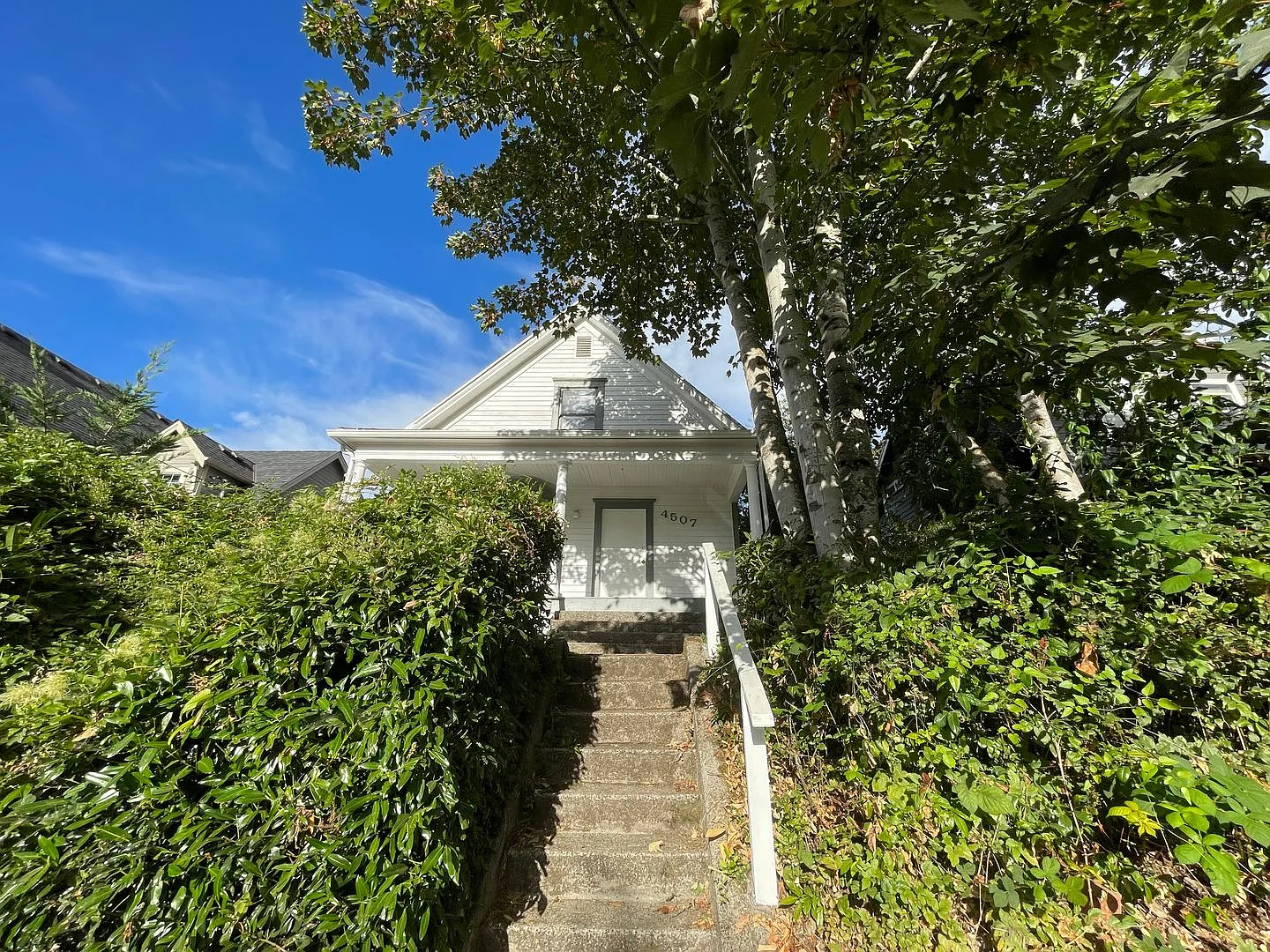 Classic Farmhouse-Style 4-Bedroom with Covered Porch, Huge Windows, Fenced Yard — Photo 1